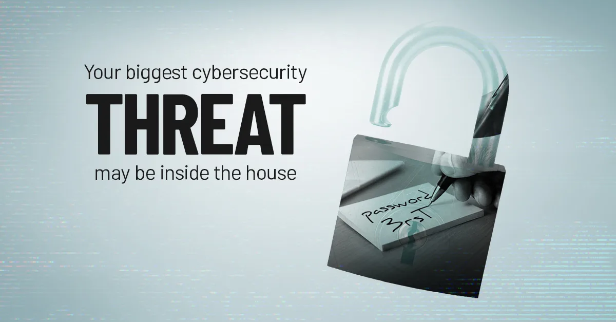 A hand writes a password on a sticky note next to a keyboard, illustrating a common insider security risk.